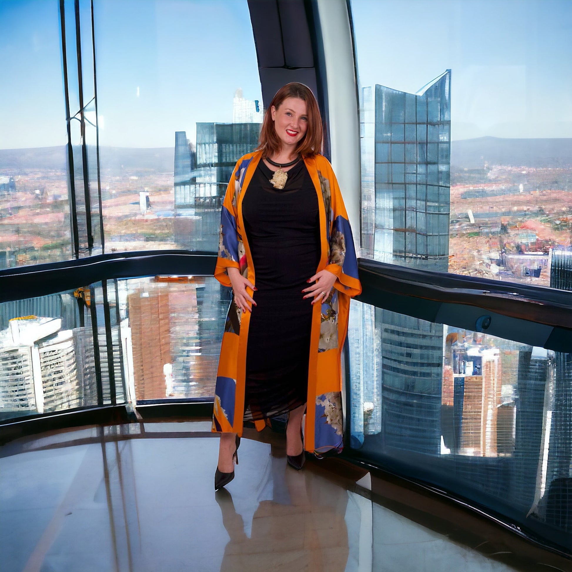 Bird of Paradise Cherry Blossom Silk Kimono styled with the Boudicca Summer Black Dress and Quartz Jewelry by Veronique Designs, creating a chic ensemble. City Background.