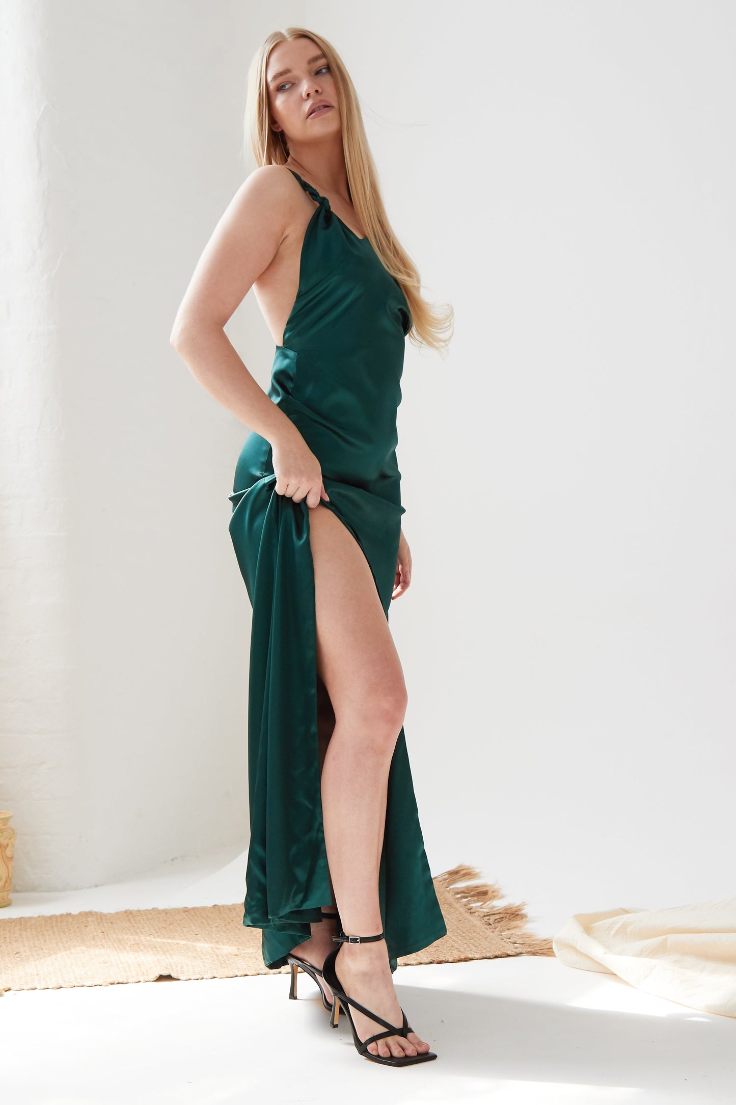 a woman in a Sarvin Backless Maxi Dress posing for a photo.