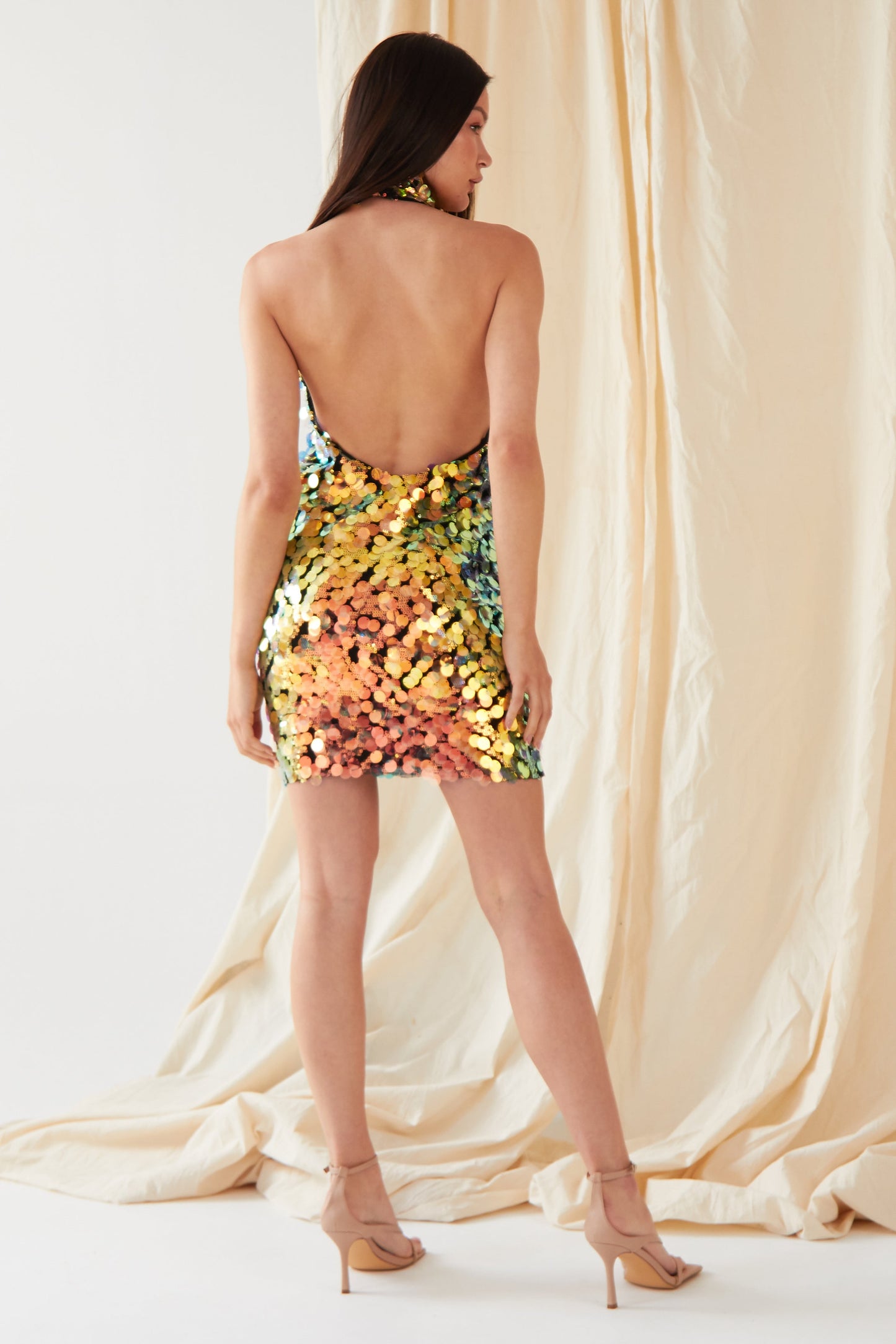 the back view of a woman in a Sarvin Sequin Mini Dress.