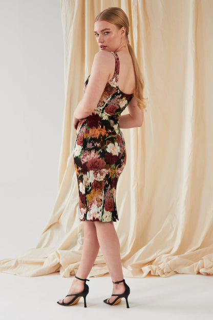 The model is wearing a Sarvin Sleeveless Floral Bodycon Dress.