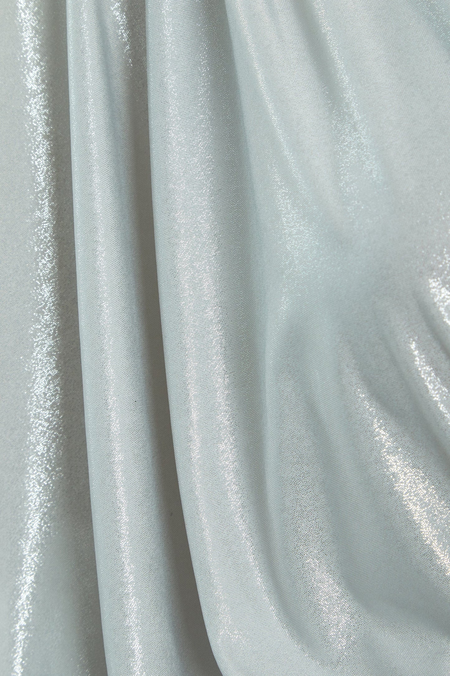 A close up of a Sarvin Batwing Sleeve Dress in light blue fabric.