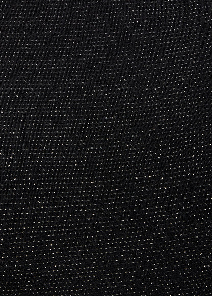 a close up of a Sarvin Black Cowl Back Gown with dots on it.