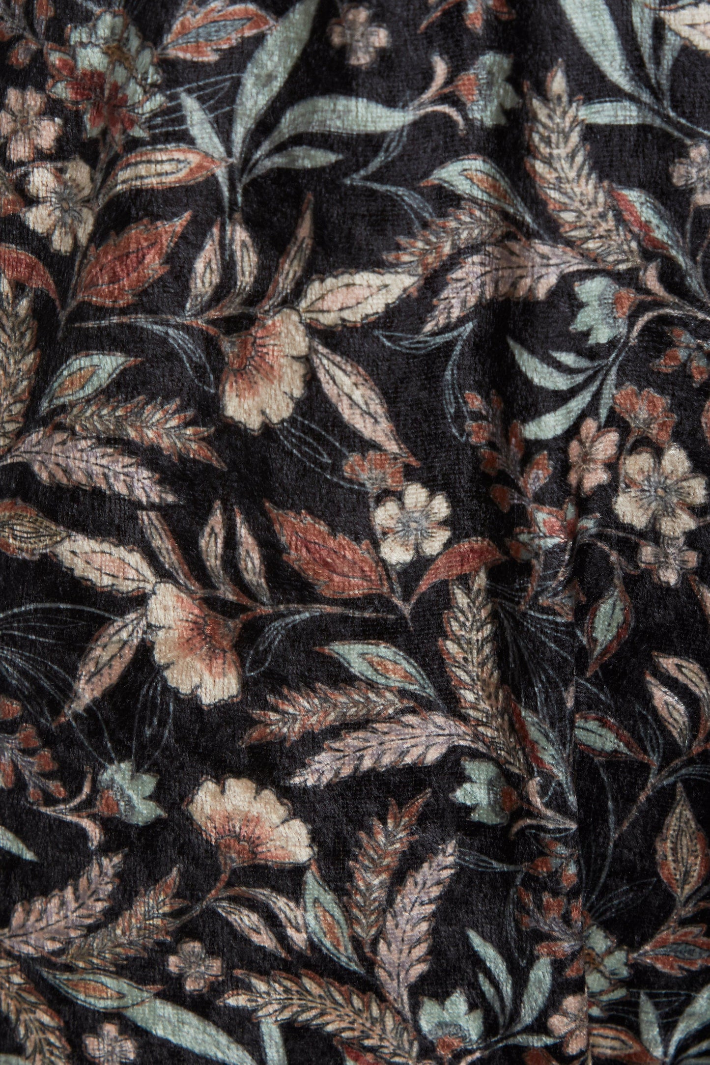 a close up of a Sarvin Floral Velvet Backless Jumpsuit with a floral pattern.