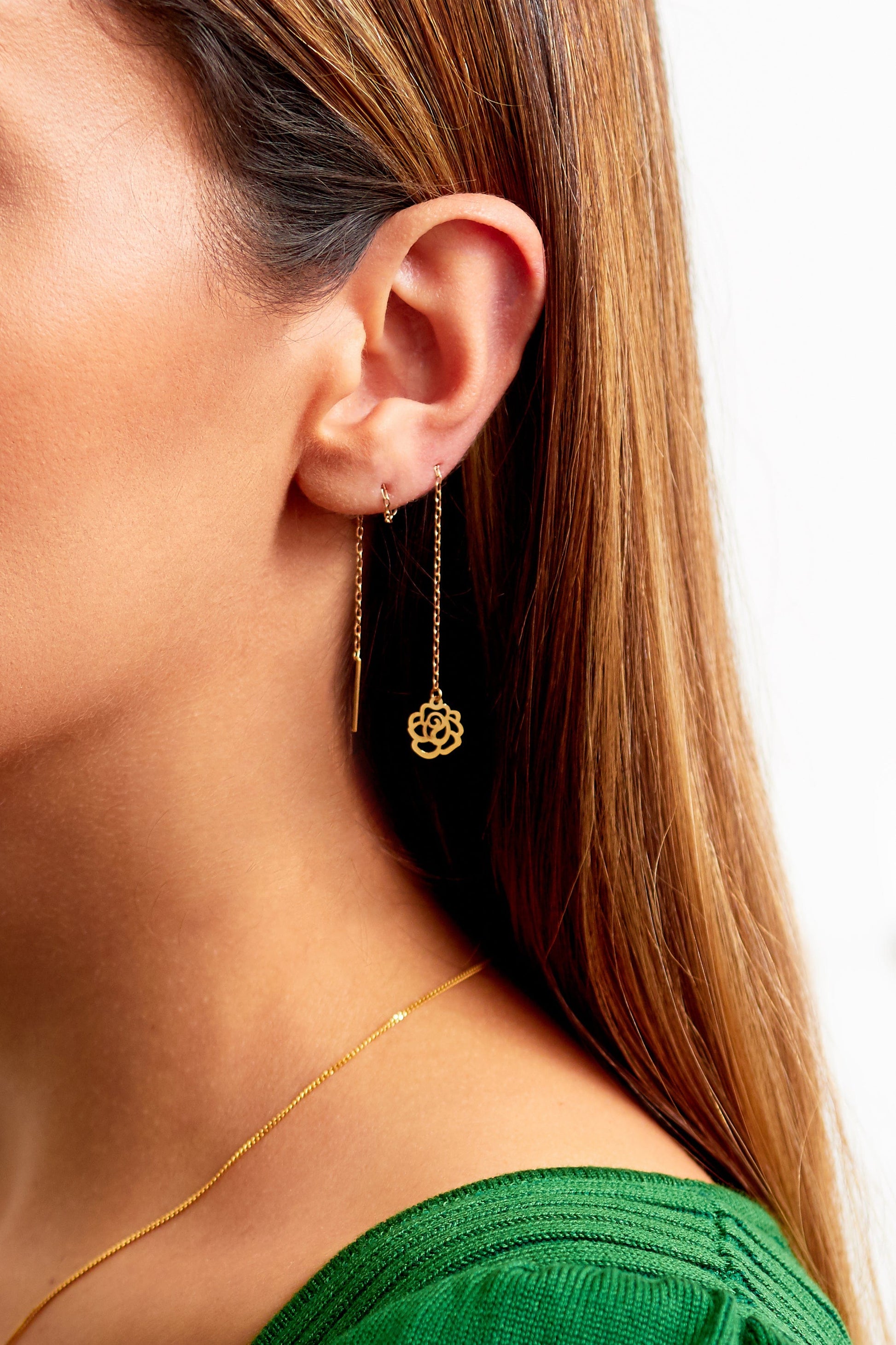 a woman wearing a green top and Sarvin Gold Thread Through Earrings.