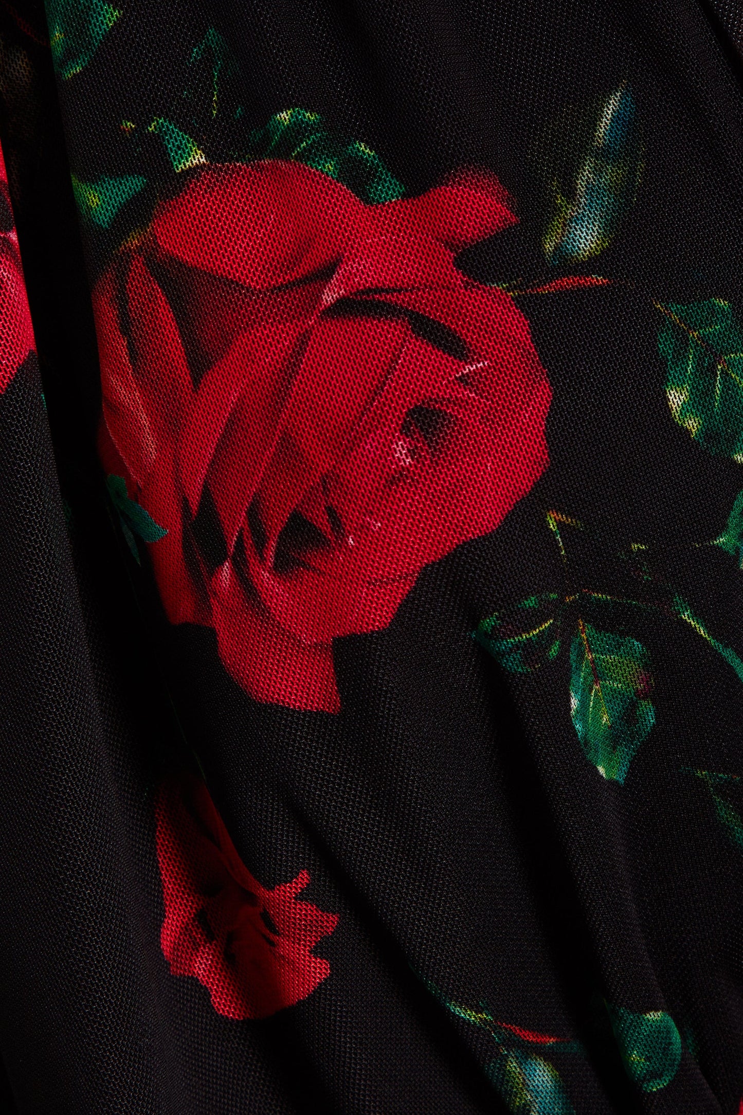 A close up of a Sarvin Ruched Bodycon Dress with red roses on it.